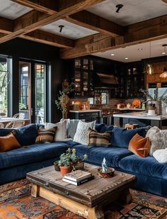 a living room filled with blue couches and pillows on top of a wooden table