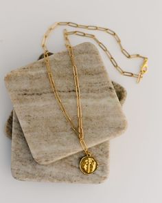 Discover a timeless symbol of hope with our Eternal Hope Necklace. Featuring a large textured round/cross pendant on a trendy paperclip chain, its longer length is perfect for layering with other necklaces. Add a touch of style and meaning to any outfit. Details: 20" gold-plated stainless steel paperclip chain 2" drop Handmade in Haiti by Vi Bella Artisans Chunky Cross Necklace, Faith Based Jewelry, Symbol Of Hope, Paperclip Necklace, Hope Necklace, Timeless Symbol, Necklace Cross, Hope Symbol, Faith Based