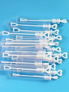 several toothbrushes are lined up on a blue surface with white caps and handles