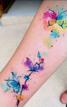 colorful watercolor tattoos with butterflies on the arm