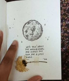 a hand is holding an open book with a drawing on it that says let's talk about the moon and stars