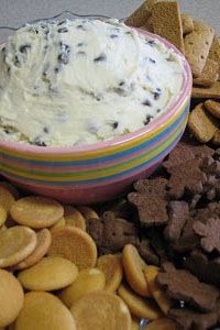 a plate full of cookies, crackers and dip