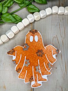 a cookie shaped like a ginger on top of a table