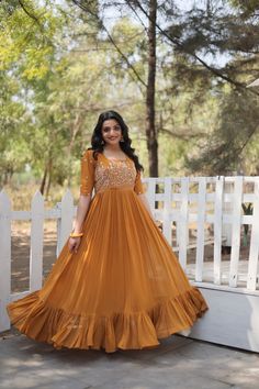 Faux Georgette gown for women,designer Anarkali dress with bigger flair,evening wear gown with sequin embroidery work,designer gown for gift GOWN   :- 👇 Color : 1) Brownish orange 2) Rose vale 👉🏻 FABRIC & WORK :- Faux Georgette With Sequins Multi threaded Embroidered work  👉🏻 SIZE :- M(38), L(40), XL(42), XXL(44) 👉🏻 LENGTH :- 56 INCH 👉🏻 FLAIR :- 5 MTR  👉🏻 LINING :- Cotton  (Full Inner Top To Bottom) 👉🏻 SLEEVES :- Puff Sleeves  👉🏻 STITCHING TYPE:- Frill Stitch 👉🏻 NECK TYPE :- Squ Indian Party Wear Dresses, डिजाइनर कपड़े, Party Wear Gowns, Designer Anarkali Dresses, Long Frock Designs, Yellow Gown, Designer Gown, Frock For Women, Indian Party Wear