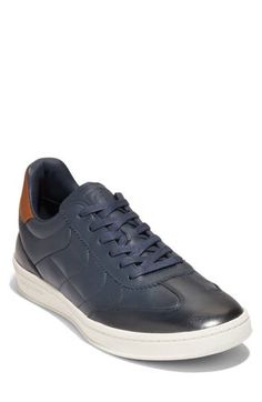 This soccer-inspired sneaker is lightweight and flexible with an anatomical sockliner and padding in the heel for exceptional fit and comfort. Lace-up style Cushioned EVA footbed with arch support Leather upper, textile lining & rubber sole Imported Navy Sporty Sneakers With Contrast Sole, Sporty Navy Sneakers With Contrast Sole, Navy Mid-top Sporty Sneakers, Sporty Navy Sneakers With Rubber Sole, Navy Leather High-top Sneakers For Sports, Navy Textured Sole Slip-on Sneakers, Navy Leather Sporty Sneakers, Navy Slip-on Sneakers With Textured Sole, Sporty Navy Leather Sneakers