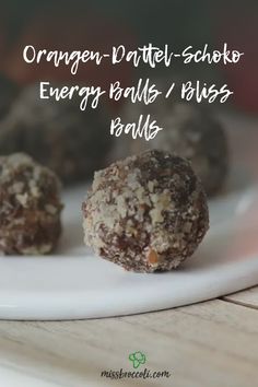 three chocolate balls on a plate with the words orange - datel - schoko energy balls / bliss balls