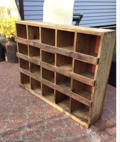 an old wooden bookcase is sitting on the ground