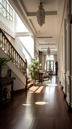 the sun shines through the windows in an elegant house with wood floors and white walls