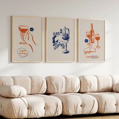 three paintings hang on the wall above a couch