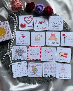 playing cards are laid out on a table with beads and flowers around them, including roses