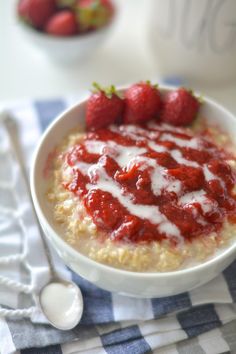 a bowl of oatmeal with strawberries on top