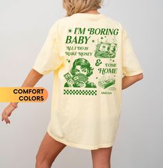 * This Comfort Color 1717 shirt is relaxed fit. If you want it to fit very oversized, we recommend sizing up 2-3 sizes! * Unisex Adult Sizing Comfort Color 1717 Shirts Props used in photos are NOT included with purchase FIBER COMPOSITION - 100% ring-spun cotton - Garment-dyed fabric CARE INSTRUCTIONS - Machine wash: Cold (Max 30C or 90F) - Do not bleach - Wash inside out with like colors  - Tumble dry: low heat  - Iron, steam or dry in low heat only - Do not dry clean SIZE - If you want a comfor Retro Yellow Shirt With Screen Print, Yellow Graphic Tee Shirt With Text Print, Yellow Graphic Tee With Text Print, Yellow Retro Shirt With Letter Print, Yellow Short Sleeve Shirt With Letter Print, Yellow Top With Funny Print For Streetwear, Cute Yellow Shirt With Graphic Print, Trendy Yellow Shirt With Screen Print, Cute Yellow Tops With Text Print