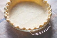 a pie crust in a glass dish on a table