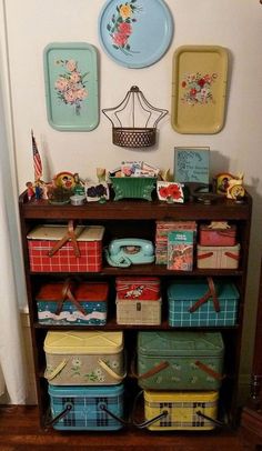 a wooden shelf filled with lots of different colored boxes and baskets on top of it