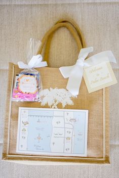 a bag with some items in it sitting on a table next to a card and envelope