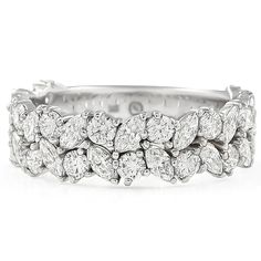 a white gold ring with three rows of diamonds on the sides and two rows of leaves in