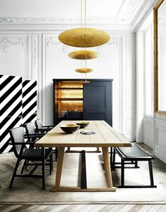 an image of a dining room setting with chairs and a table in the foreground