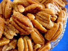 a pile of pecans sitting on top of a blue table