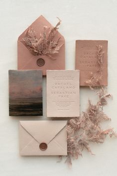 the wedding stationery is laid out and ready to be used as an envelope, cards, and other items