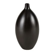 a black vase sitting on top of a white table