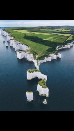 an instagram page with the image of white cliffs and green grass in the background