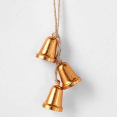 three golden bells hanging from a rope