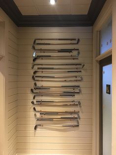 there is a wall sculpture made out of skis in the corner of a room