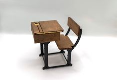 a miniature desk and chair made out of wood with metal legs, on white background