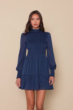 The Lulus Heartful Romance Navy Striped Smocked Long Sleeve Mini Dress has our hearts forever and always! Airy woven chiffon (with textured dots, metallic lurex, and tonal stripes throughout) shapes a ruffle-trimmed mock neckline, a smocked bodice, and long sheer sleeves with ruffles at the shoulders and smocking at the cuffs. Flowy mini skirt has a tiered hem. Back keyhole secures with a button closure. Fit: This garment fits true to size. Length: Mid-thigh. Size medium measures 35" from should Bach Bash, Flowy Mini Skirt, Forever And Always, Mock Neckline, Long Sleeve Mini, Sheer Sleeves, Navy Stripes, Long Sleeve Mini Dress, Ruffle Trim