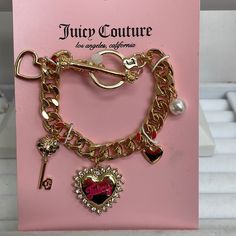 This Is A Fun Juicy Couture Gold Tone Charm Bracelet With Toggle Closure. 5 Charms Include 2 Hearts, A Multi Color Rhinestone Key, A Faux Pearl And A Big Rhinestone Heart With Juicy Writing In Pink. Brand New, Never Been Worn. Juicy Couture Clothes, Juicy Couture Charms Bracelet, Mcbling Fashion, Juicy Couture Bracelet, 2 Hearts, Juicy Couture Accessories, Juicy Couture Charms, Juicy Couture Jewelry, Jewelry Accessories Ideas