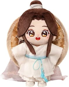 the doll is wearing a white dress with brown hair and big eyes, holding a blue ribbon around her neck