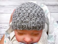 a close up of a baby wearing a knitted hat