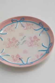 a pink and blue plate with flowers on it