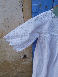 "Vintage French Edwardian 1900 white cotton antique baptism dress Christening gown for a child . Made with a lovely white textured white cotton fabric . Adorned all around the top yoke , sleeves & at the bottom of the skirt with gorgeous handmade floral embroideries . There are 2 buttons at the back . hight waist . Ruffle at the bottom . 100% cotton Color : white Size : fit to a child aged 6 month/1 year ( aproximativly) Lenght : 29.5 \" ( 75 cm) Shoulder to shoulder : 8 \"( 20 cm) Chest : 1 White Cotton Baptism Dress For Summer, White Swiss Dot Cotton Dress, Summer Baptism Dress With Lace Work, White Spring Baptism Dress, Summer White Cotton Baptism Dress, White Cotton Pastoral Dress, White Baptism Dress With Broderie Anglaise For Summer, White Pastoral Cotton Dress, Summer Cotton Baptism Dress