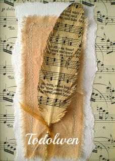 a piece of paper with music notes on it and a feather pinned to the side