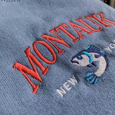 "*SIZES ARE UNISEX* -For women, I'd suggest your usual size for a regular fit (size up for a more relaxed fit). Men should size up for a more relaxed fit. *these sweatshirts are extra comfy when oversized 🐟 \"Montauk New York\" embroidered on a sporty cute vintage-style crewneck. A vintage styled sweatshirt bound to keep you warm in the colder months. A pre-shrunk, classic fit sweater that's made with air-jet spun yarn for a soft feel and reduced pilling. Your new favorite sweatshirt! * 50% cot Casual Crew Neck Sweater With Embroidered Logo, Blue Crew Neck Hoodie With Embroidered Logo, Casual Crew Neck Hoodie With Letter Embroidery, Casual Hoodie With Embroidered Graphics And Crew Neck, Casual Crew Neck Hoodie With Embroidered Graphics, Casual Crew Hoodie With Letter Embroidery, Casual Crew Sweatshirt With Embroidered Graphics, Casual Crew Neck Sweater With Embroidered Text, Casual Embroidered Crew Neck Hoodie