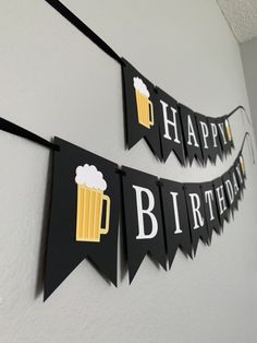 happy birthday banner with beer mugs hanging on the wall and bunting below it