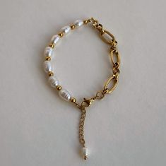 The bracelet is crafted with a combination of natural freshwater pearls and a stainless steel chain. This accessory will easily add a touch of accent to your everyday look. Material: Stainless steel & Freshwater Pearls. Finish: 18k Gold Plated. Width: 5mm. Length: 18,5cm+4cm. 🔸more from us🔸 https://www.etsy.com/shop/DoraJewelryAccessory White Metal Pearl Bracelet With Jubilee Details, Metal Bracelets With Pearl Drop For Gift, Adjustable Metal Chain Bracelet With Pearl Charm, Metal Pearl Bracelet With Charm As Gift, Metal Pearl Bracelet With Pearl Charm As Gift, Pearl Charm Bracelet In Metal As A Gift, Metal Pearl Bracelet With Pearl Charm For Gifts, Adjustable Metal Pearl Bracelet With Pearl Charm, Pearl Chain Bracelet With Adjustable Chain As Gift