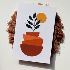 a card with an orange and red vase on it