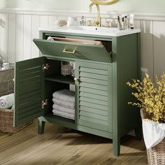 a bathroom with green cabinet and white sink