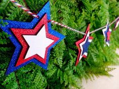 red, white and blue stars hanging from a tree