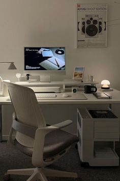 a white desk with a computer monitor, keyboard and mouse next to it on top of a chair