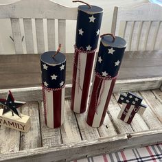 three patriotic candles are sitting on a table