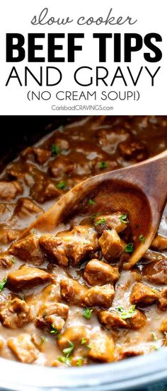 beef tips and gravy in a crock pot with a wooden spoon on the side