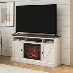 an entertainment center with a fireplace in the middle and a flat screen tv above it