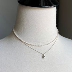 "There are 2 necklaces in this listing.   Necklace 1:   Sterling silver puff heart hangs from a tiny curb chain in bright 925 sterling silver. Details of Necklace 1: - Length of the necklace - 16\" with the option to add a 1.5\" extender chain - Dainty sterling silver curb chain (approx 1mm) & sterling silver lobster trigger clasp - Dainty puff heart in sterling silver - 6X9mm Necklace 2:  Tiny white freshwater pearl necklace with sterling silver lobster clasp.  Details of Necklace 2: - Length o Dainty Heart Necklace, Tiny Heart Necklace, White Pearl Necklace, Puffed Heart, Freshwater Pearl Necklace, Silver Heart Necklace, White Freshwater Pearl, Tiny Heart, Pearl Choker