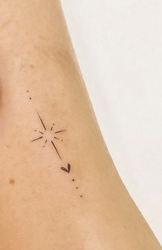 a woman's leg with a small star tattoo on her left side ribcage