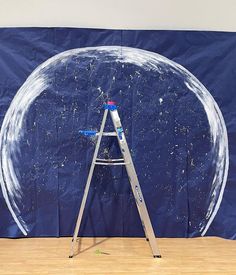 a ladder is standing in front of a giant bubble