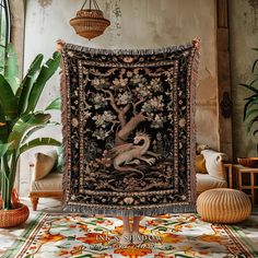 a tapestry hanging on the wall in a room with potted plants and other decorations