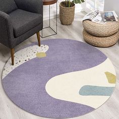 a living room area with a chair, rug and potted plant on the floor